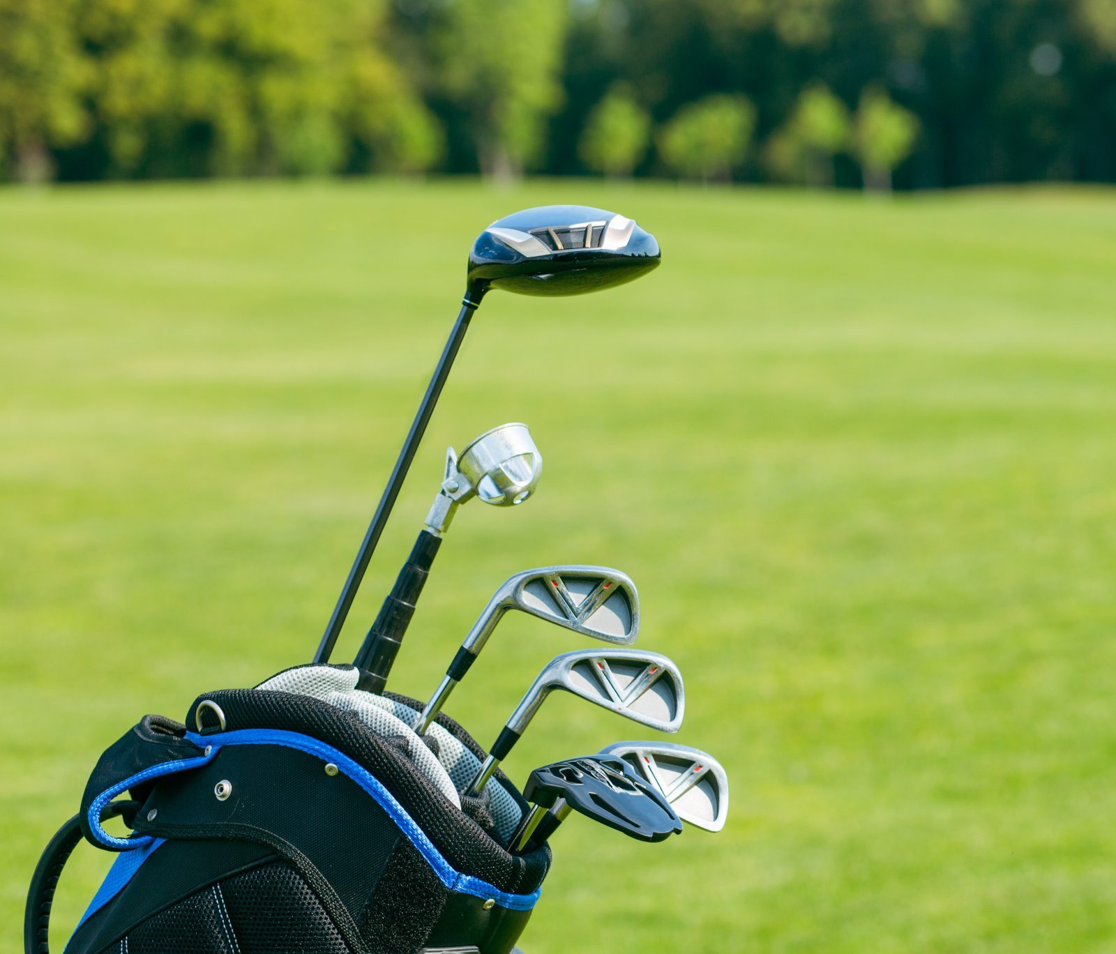 Golf clubs in a golf bag isolated. Set of golf clubs for a golfer. Copy Space. green Background. Close-up. High quality photo